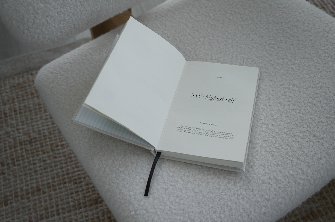 Open book on a textured surface with text visible