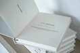 Load image into Gallery viewer, Stack of white books with text on a light surface Thread Vision Spotlight, HMBDY
