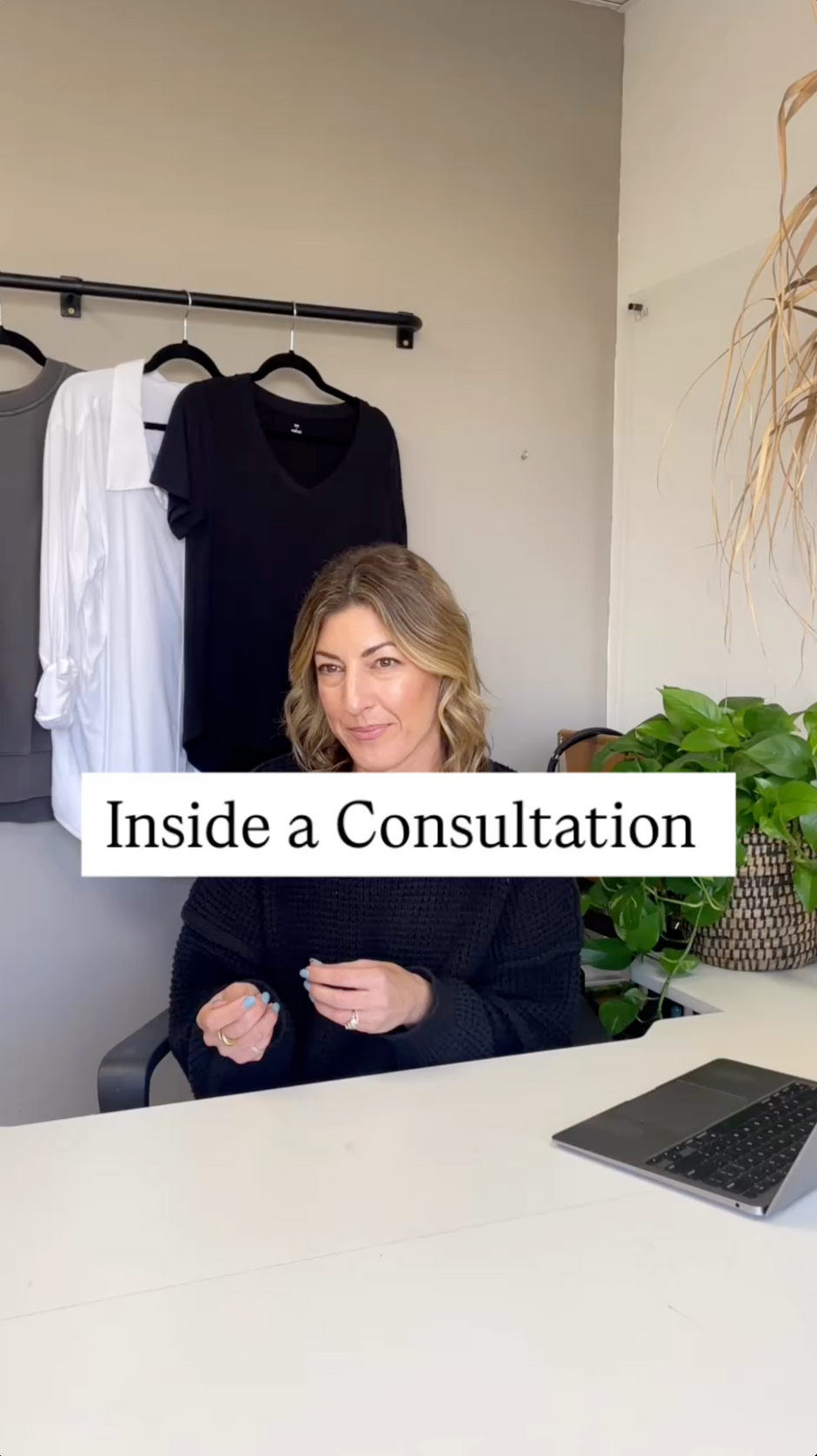 Woman sitting at a desk with clothing on a rack in the background, labeled 'Inside a Consultation'. - Thread Vision, Branded Photo