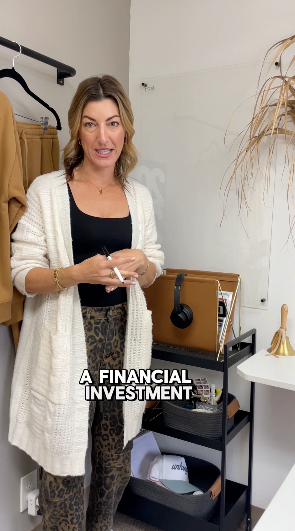 Woman standing in a room with text overlay 'A FINANCIAL INVESTMENT'. - Thread Vision, Branded Photo