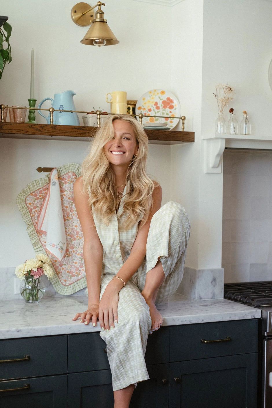 Woman sitting on a kitchen counter with a smile, surrounded by kitchen decor. - Thread Vision Client Spotlight, Maude & May by Talia Hubble