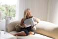 Load image into Gallery viewer, Woman sitting on a couch holding a checkered planner in a bright room. - Thread Vision Spotlight, Move Like Morgan
