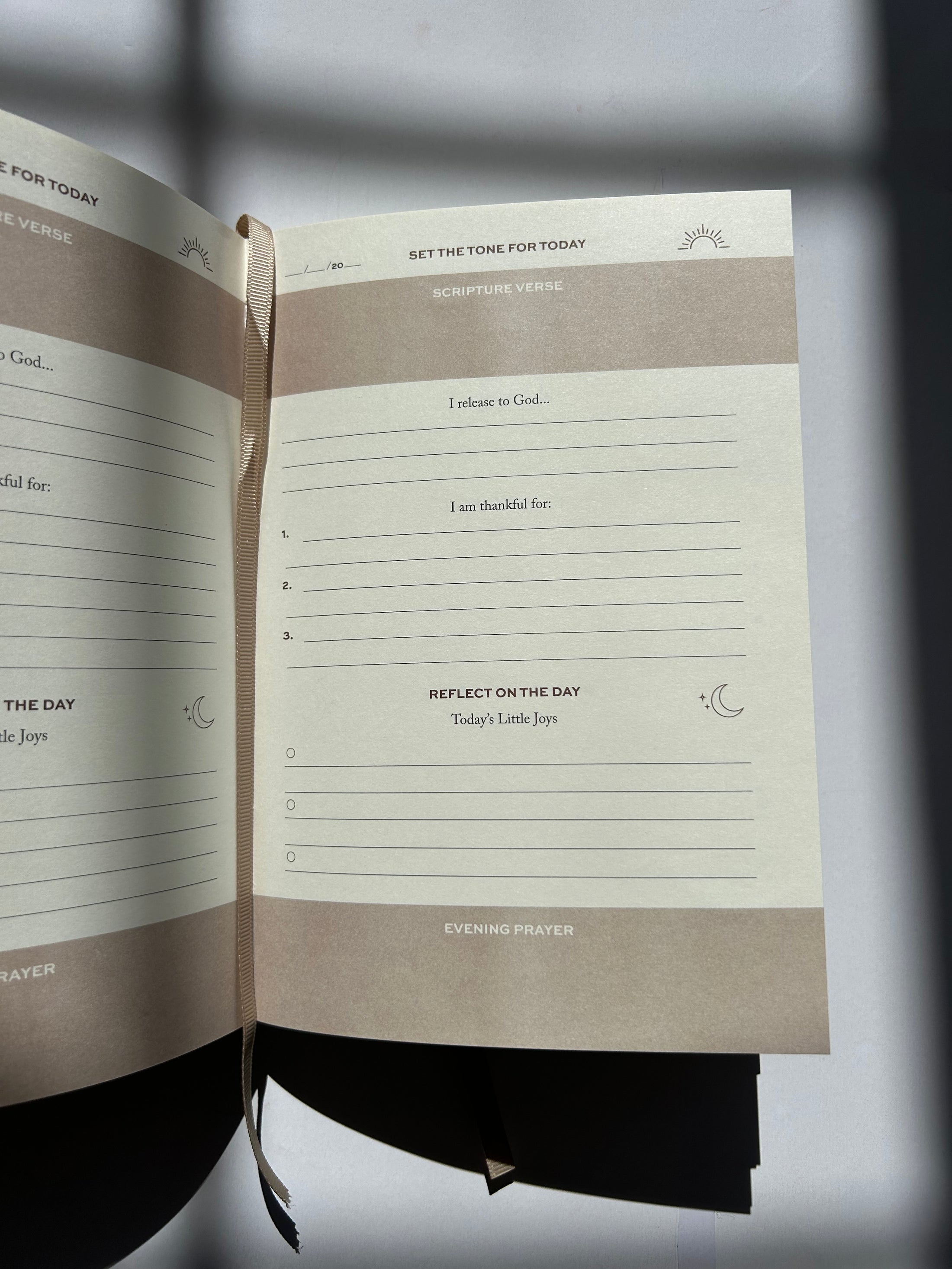 Open notebook with lined pages on a reflective surface, Thread-Vision-Karina-Faith-Diaries