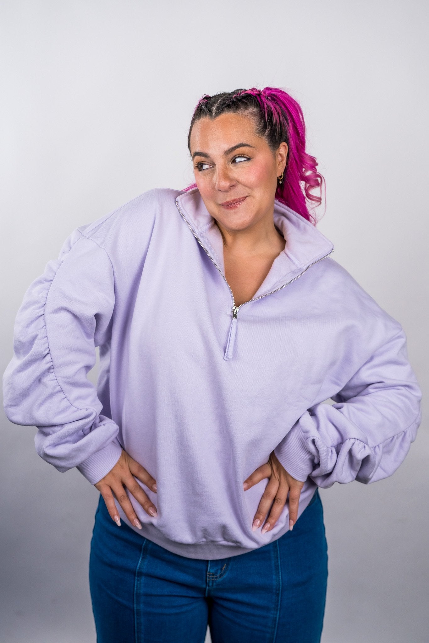 Woman wearing a light purple sweatshirt and blue jeans against a plain background - Thread Vision Client Spotlight, 10/10 Deanna Giulietti 
