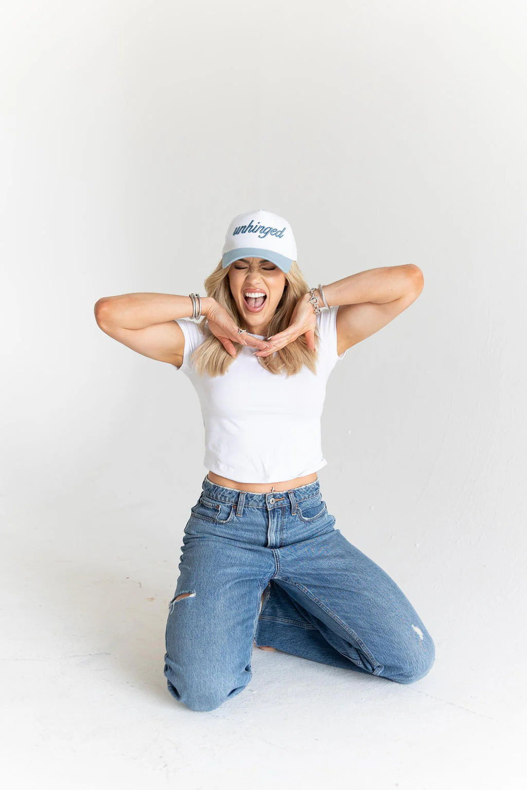 Woman wearing a white tank top, blue jeans, and a white cap with text on a white background - Thread Vision Spotlight, Move Like Morgan
