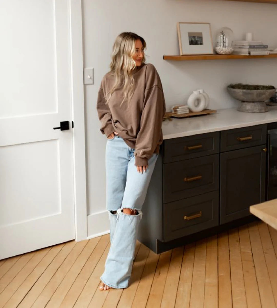 Woman standing in a modern kitchen with dark cabinets and light wood flooring. - Thread Vision Spotlight, Hill x Sarah, Sarah Hill 