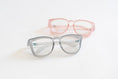 Load image into Gallery viewer, Two pairs of eyeglasses, one gray and one pink, on a white background - Thread Vision Spotlight, Remington Avenue
