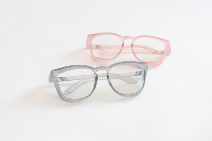 Two pairs of eyeglasses, one gray and one pink, on a white background - Thread Vision Spotlight, Remington Avenue