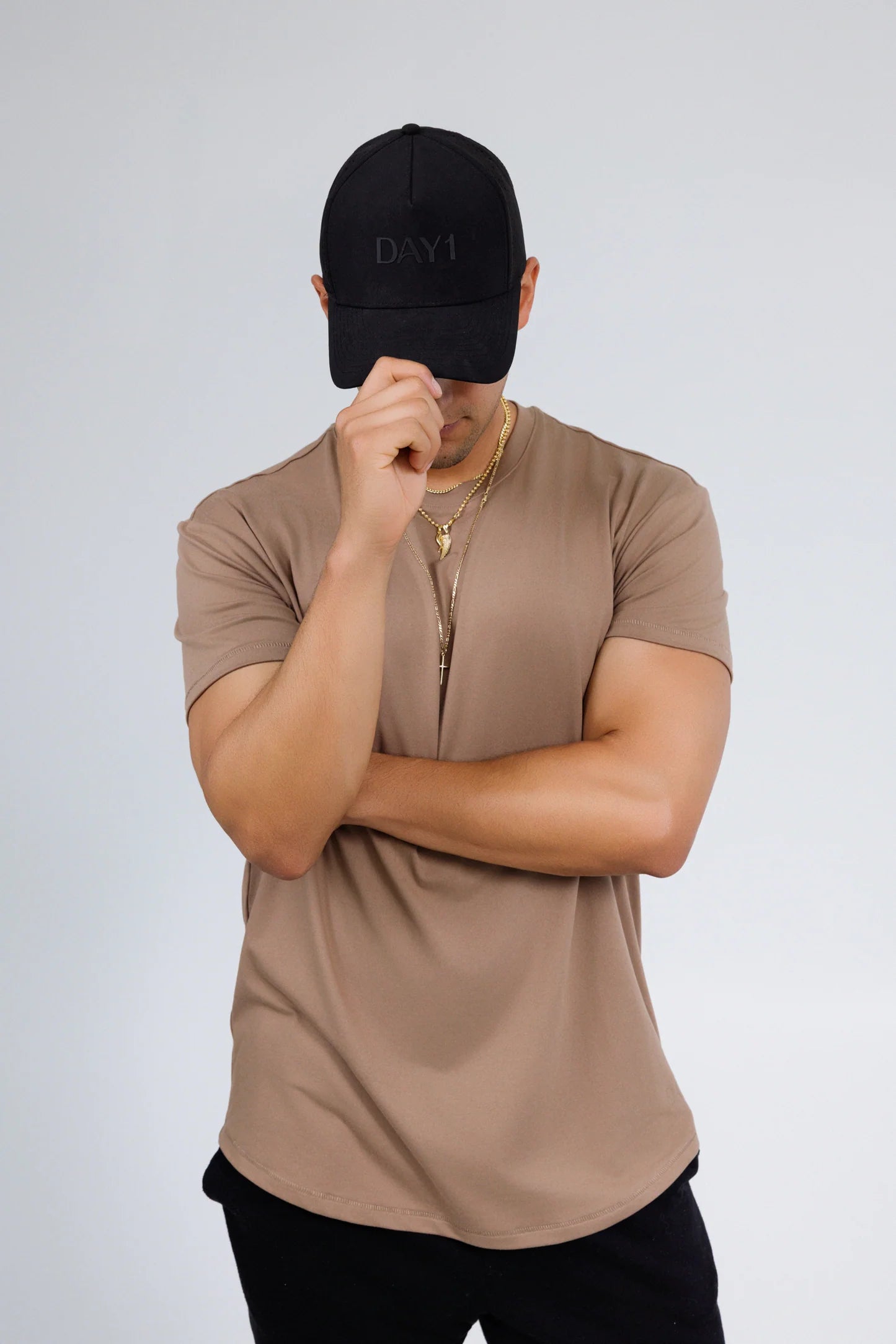 Person wearing a brown t-shirt and black cap on a white background - Thread Vision Spotlight, Day 1 Fitness, Kaylee Rogers 