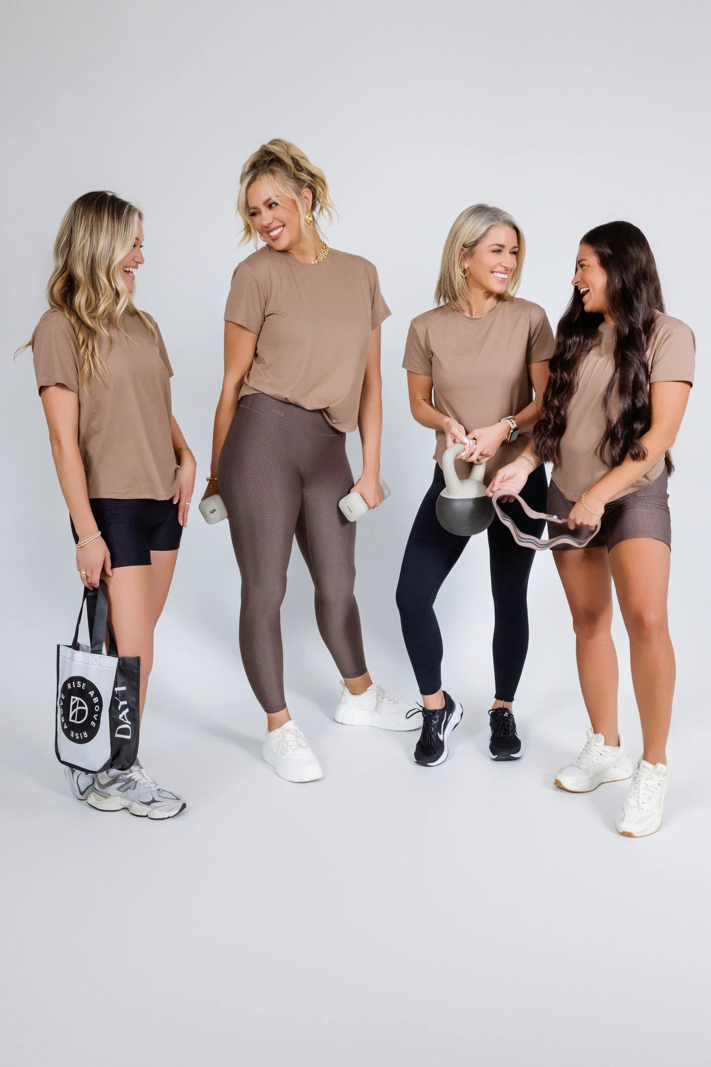 Four women wearing matching outfits with shoes on a white background - Thread Vision Spotlight, Day 1 Fitness, Kaylee Rogers 