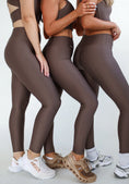 Load image into Gallery viewer, Three people wearing brown athletic leggings and sports bras on a light gray background - Thread Vision Spotlight, Day 1 Fitness, Kaylee Rogers 
