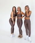 Load image into Gallery viewer, Three women wearing matching brown athletic outfits on a white background - Thread Vision Spotlight, Day 1 Fitness, Kaylee Rogers 
