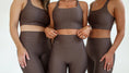 Load image into Gallery viewer, Three women wearing brown sports bras and leggings on a white background - Thread Vision Spotlight, Day 1 Fitness, Kaylee Rogers 
