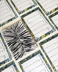 Load image into Gallery viewer, Set of notepad planners with zebra print and tropical leaf designs on a white background - Thread Vision Client Spotlight, Goldfish Kiss
