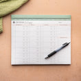 Load image into Gallery viewer, Meal planning pad with pen on a textured surface - Thread Vision Spotlight, Oh Snap Macros

