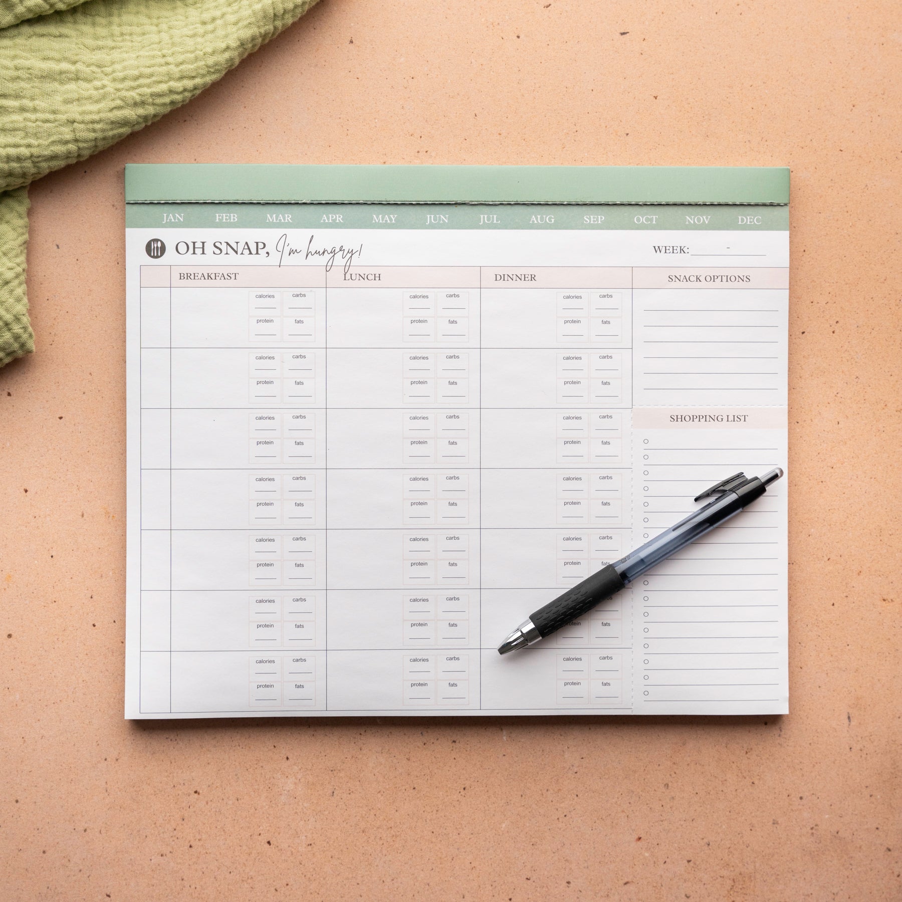 Meal planning pad with pen on a textured surface - Thread Vision Spotlight, Oh Snap Macros